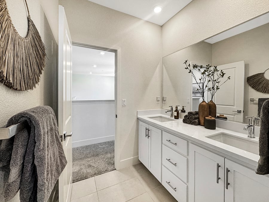 Full bathroom supporting Gold, Green, and Blue rooms. Feature's a large mirror, dual sinks, extended shower curtain, and upgraded rain shower head with filtered water.