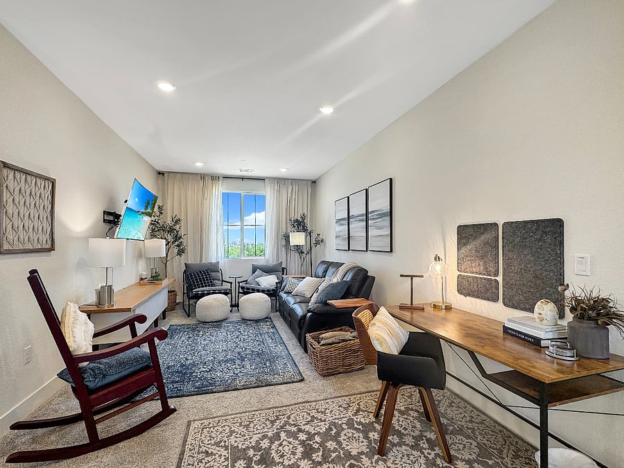 Cozy loft with smart tv, leather recliner, custom rocking chair, comfy side chairs, and task table and chair. Featuring a great view of the park!