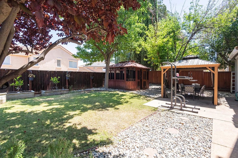 Backyard with pergola and dining tables