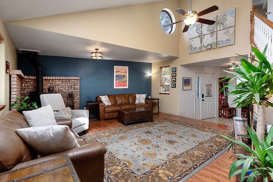 living room with vaulted ceilings, skylights, and Smart TV