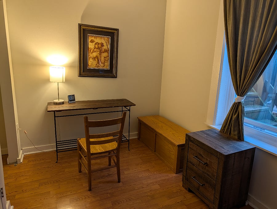 Queen size bedroom has desk