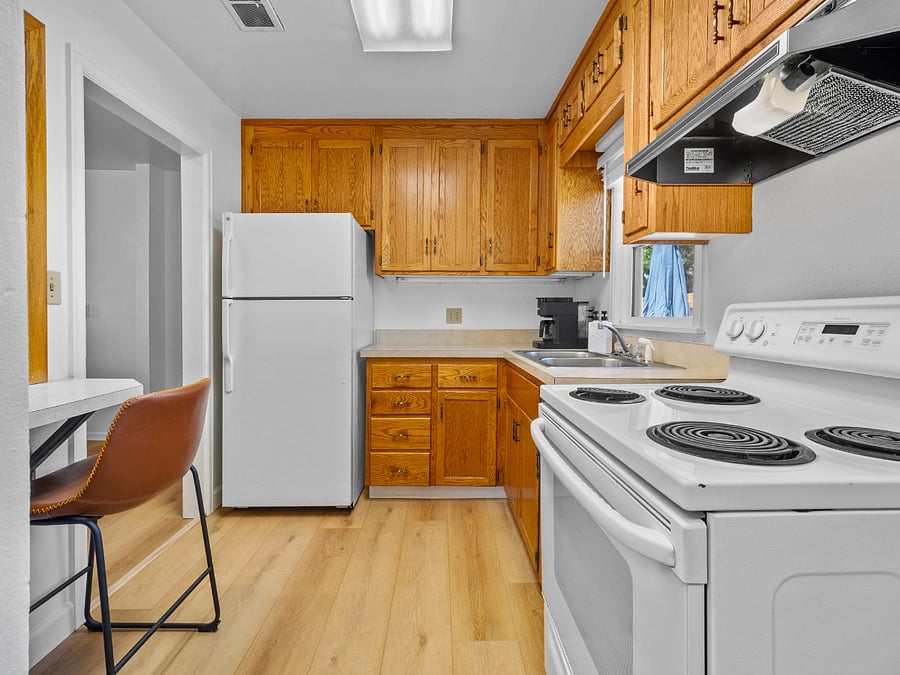 The full-sized kitchen includes a refrigerator, stove, Keurig coffee maker, microwave, toaster, and blender.