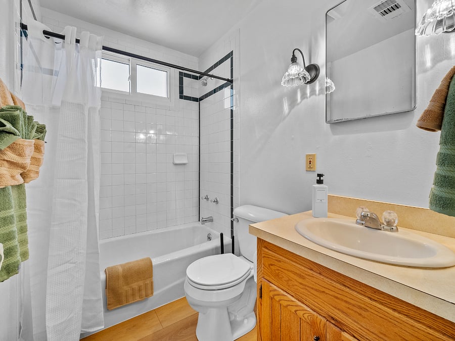 Bathroom, including a starter kit of shampoo, conditioner, and body wash, along with plush towels and makeup remover cloths.