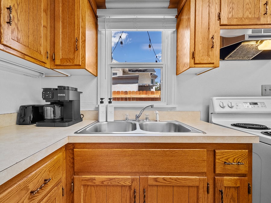 The kitchen includes a Keurig coffee maker, full sized oven range, and vent hood. 