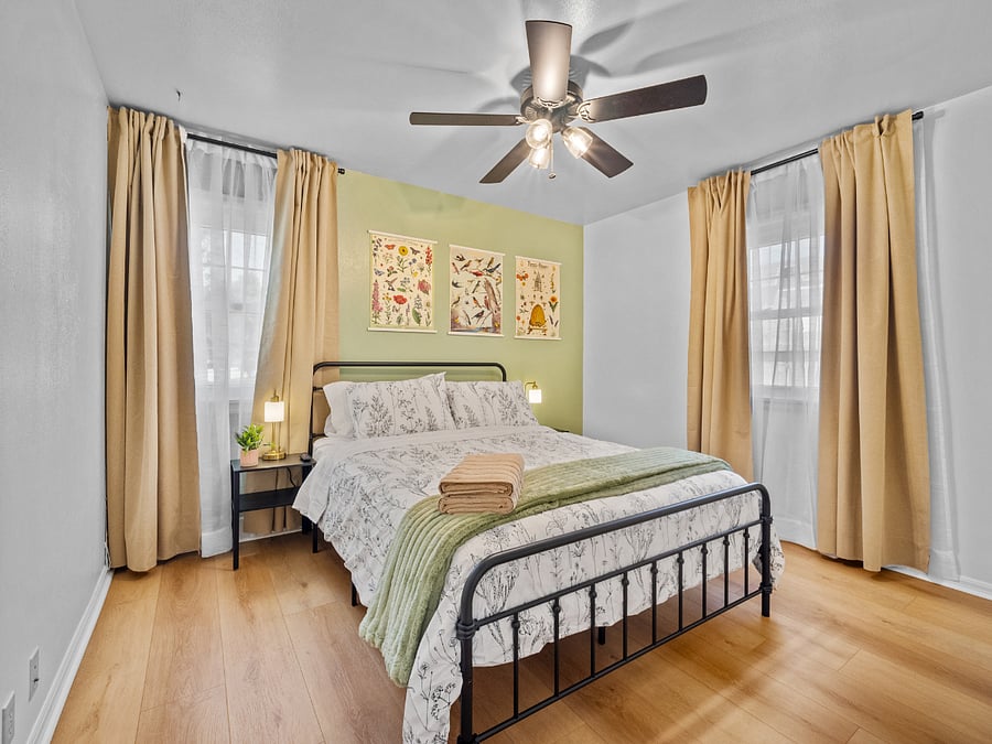 Bedroom 2 includes a queen bed with cozy linens and a Smart TV. 