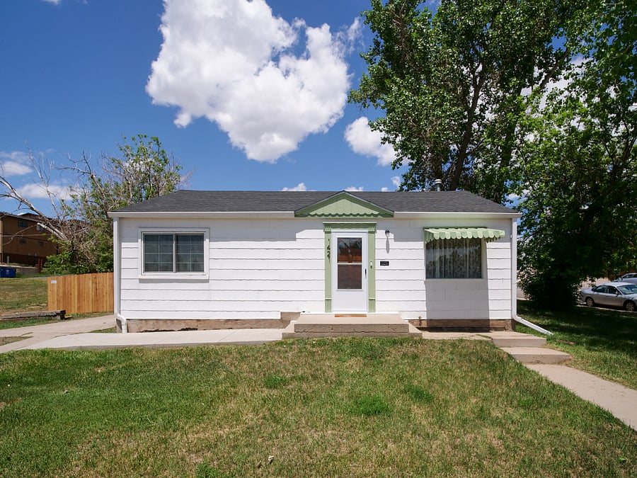 Exterior of the home. Off-street parking in the driveway is located on the left side.
