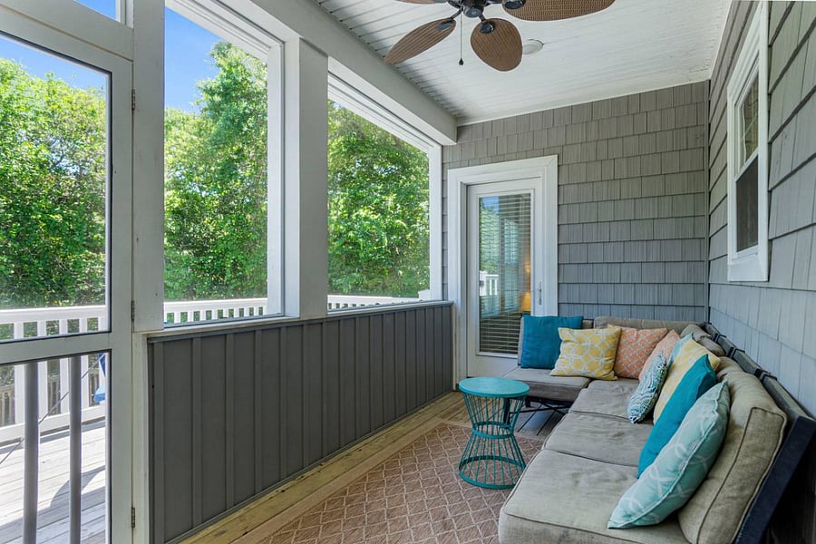 Screened porch seating area; also has dining area