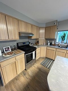 Full kitchen with gas range, ideal for those who enjoy cooking or meal prepping