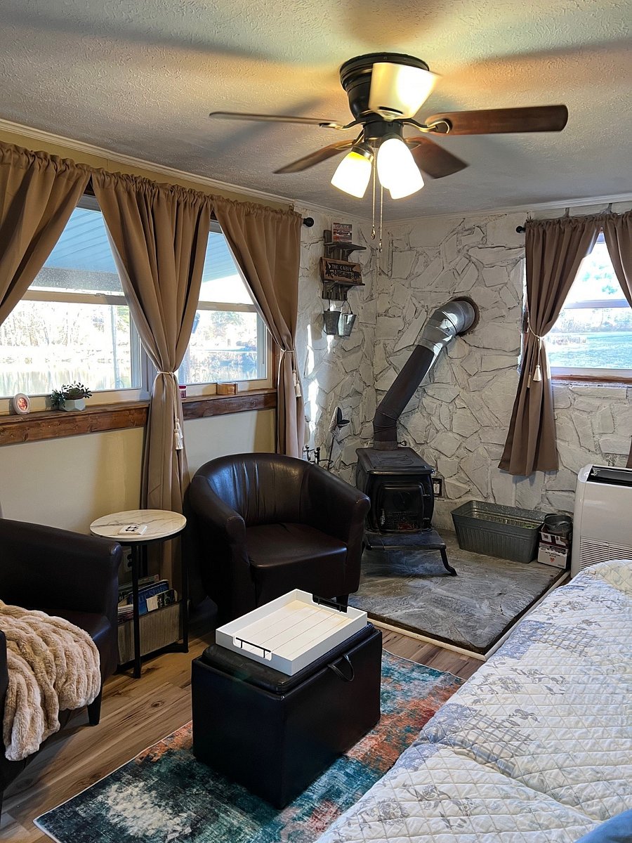 Living room with wood stove and mini split.