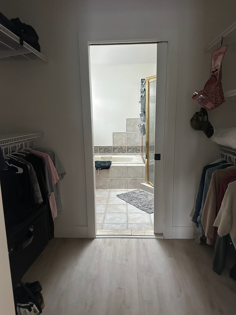 Walk-in closet in primary bedroom leads to ensuite bathroom