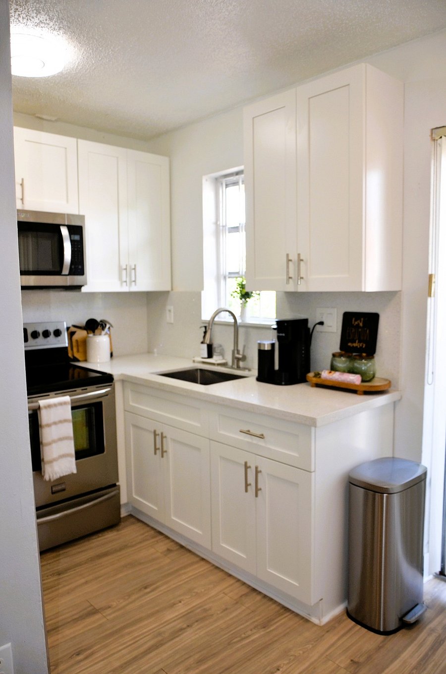 Bright, modern kitchen with quartz countertops, shaker-style cabinets, and all the essentials to make your stay comfortable.