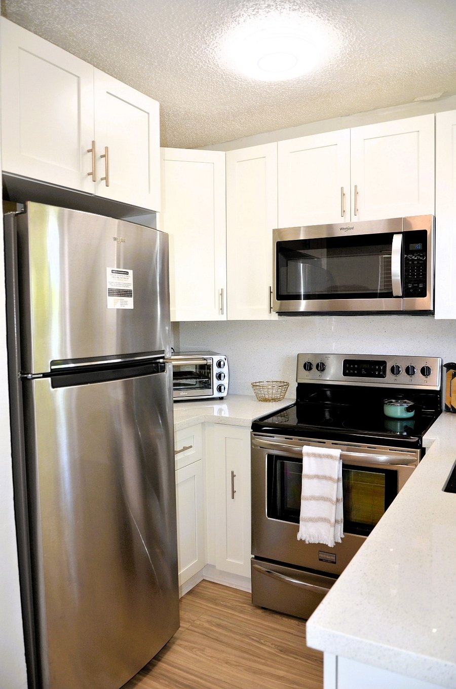 Cook with ease in a functional kitchen that includes a full-size fridge, toaster oven, and plenty of cabinet space.