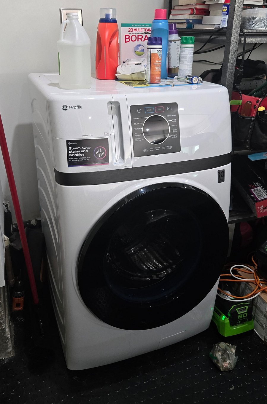 Washer and dryer combo unit located in the adjacent garage, dedicated exclusively to the unit.