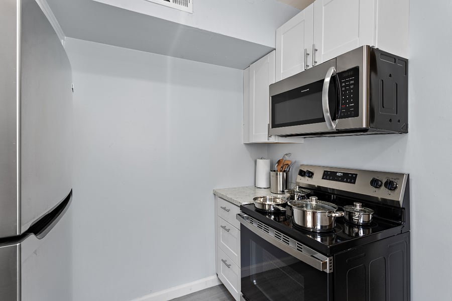 Nice kitchen with stainless steel appliances, utensils and starter supplies