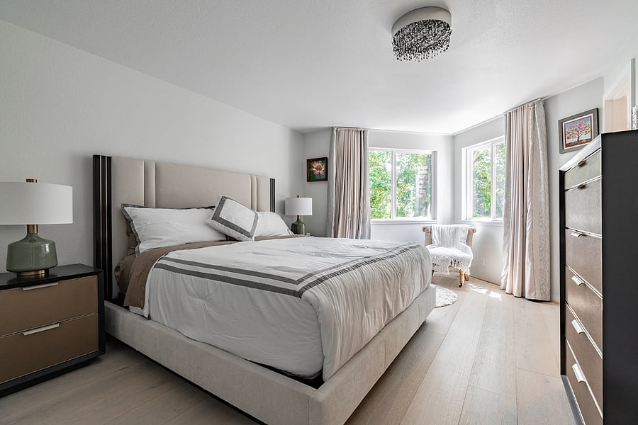 large master bedroom with high-end furniture and nice green feel
