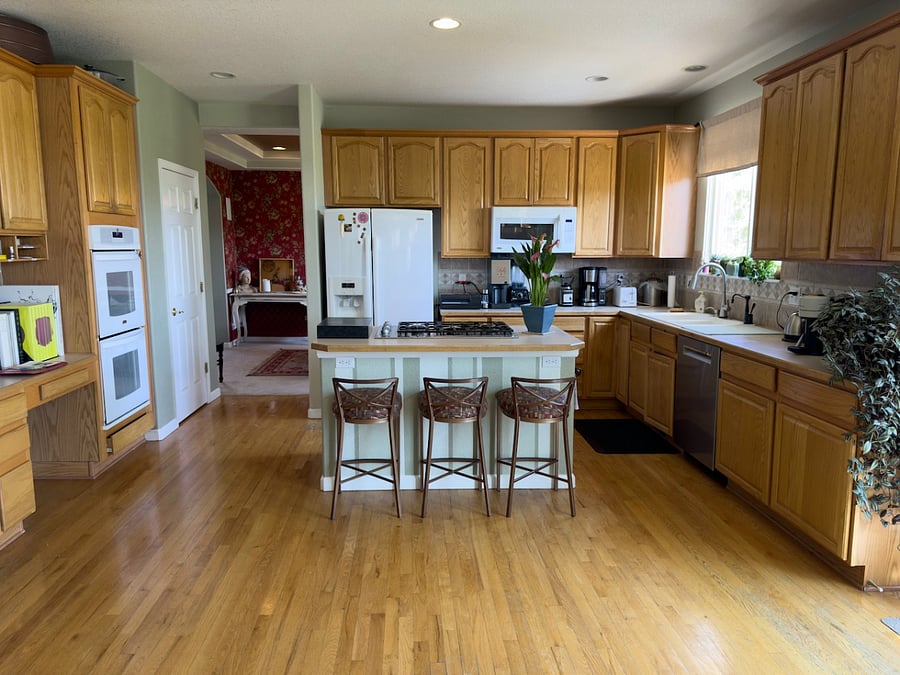Full kitchen with gas range and island ventilator.