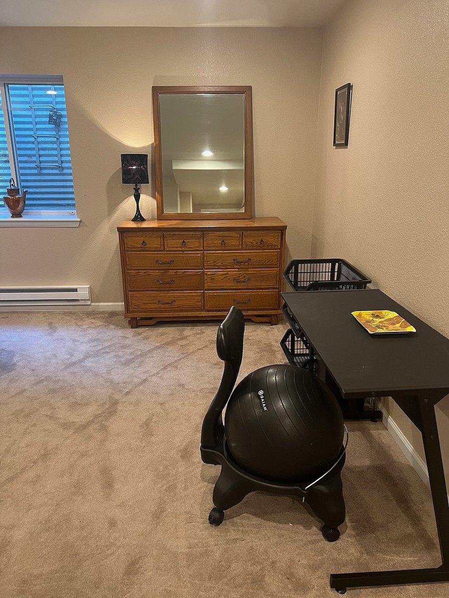 Basement bedroom desk area, also includes storage and closets.