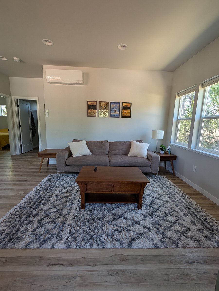 Large opened concept living room with natural light and television.