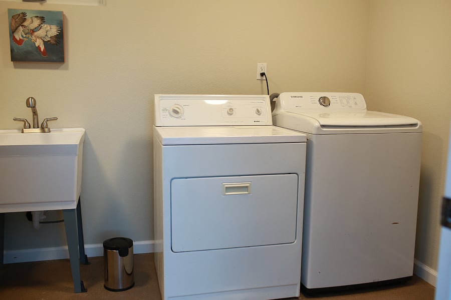 Large laundry room with sink and plenty of storage for bikes etc.