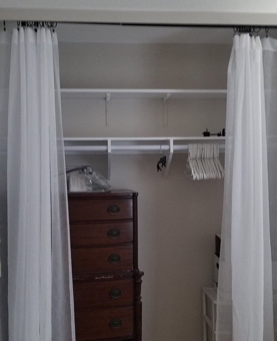 Closet space with tallboy antique chest of drawers