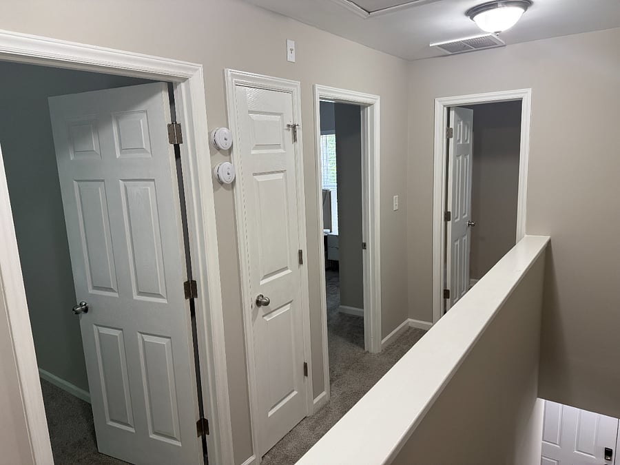 upstairs hallway leading to 2 bedrooms and the guest bathroom