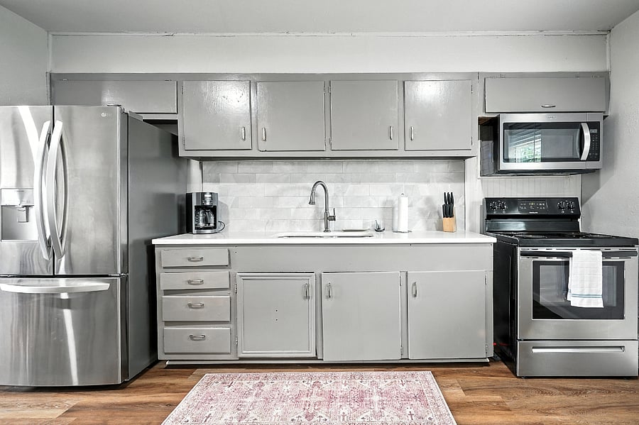 Kitchen area featuring every cookware item needed including grilling and cleaning supplies 