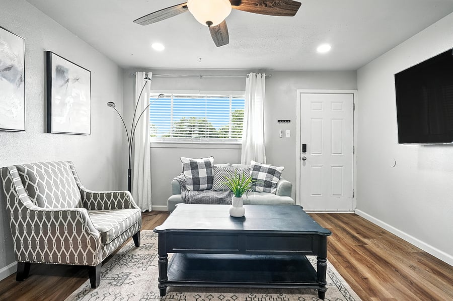 Living area with mounted TV to include Onn streaming device and coffee table with storage drawers