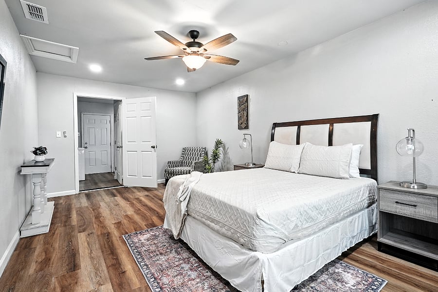 Master bedroom featuring a sitting area and entry table