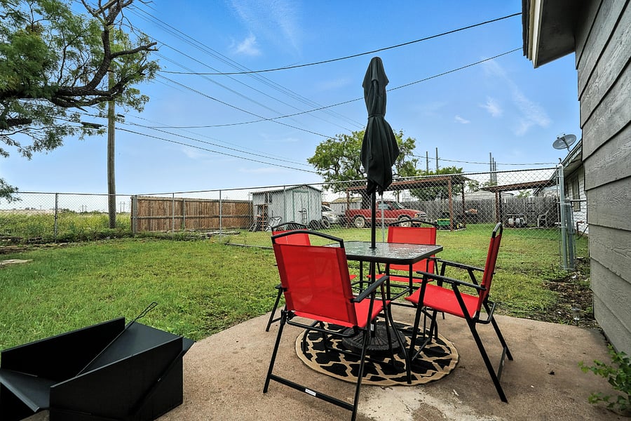 Patio with all new patio set and umbrella, fire pit, and charcoal grill