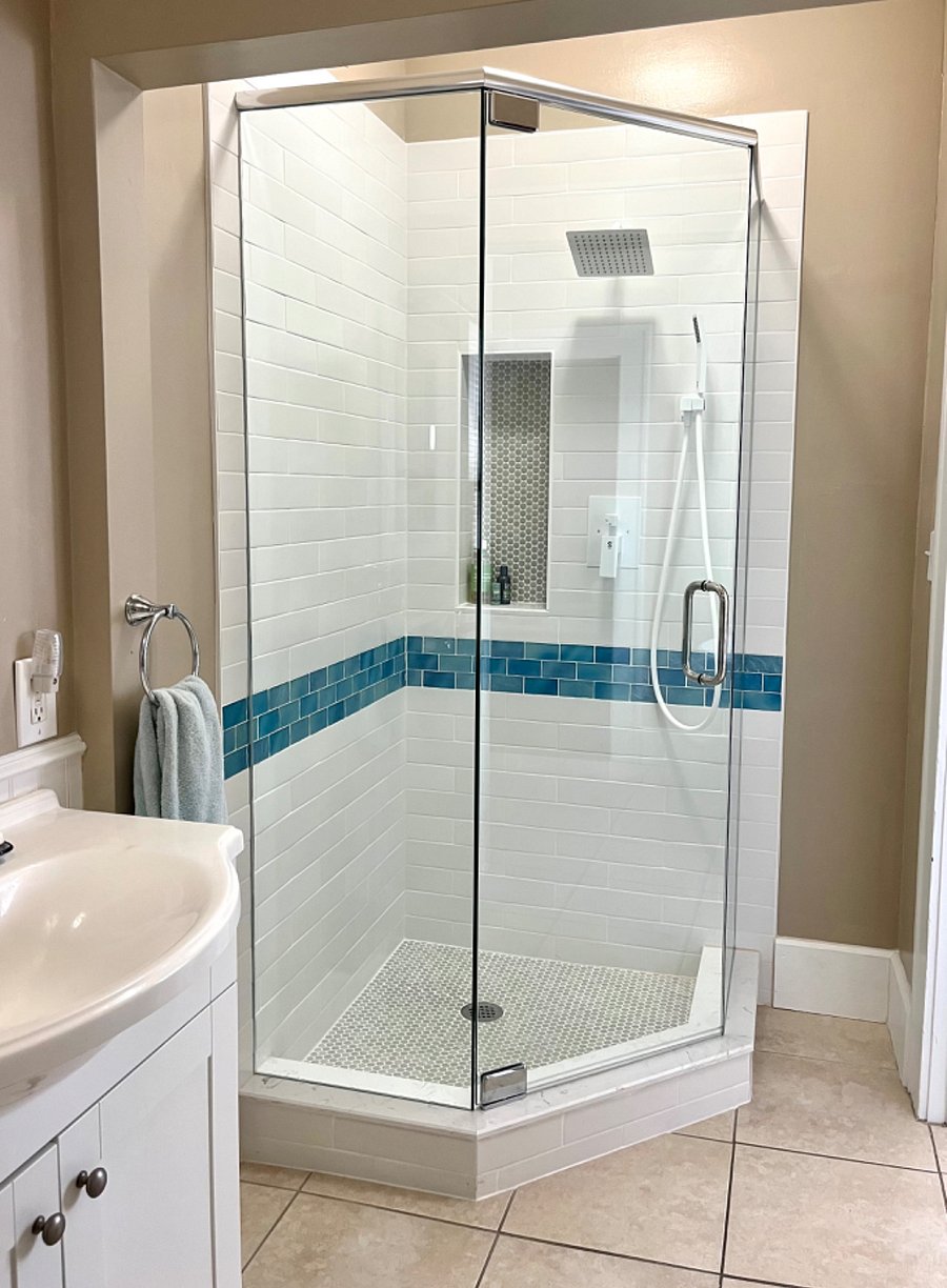 Shower includes rain shower head, hand sprayer and niche for shampoo, conditioner and body wash.