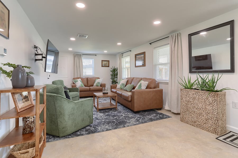 Living room with Smart TV, full size couch, love seat and 2 chairs