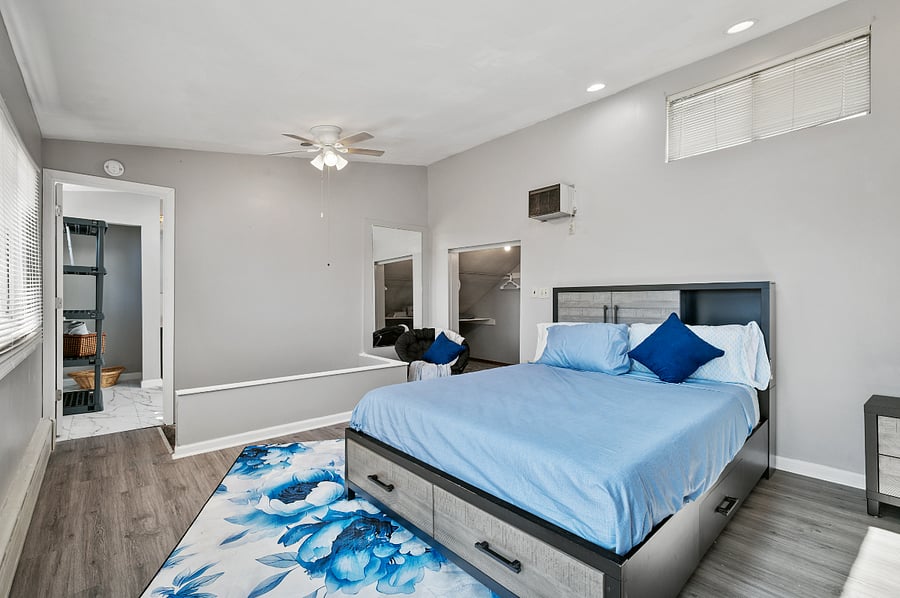 Master bedroom with queen-sized bed with underbed storage dresser drawers