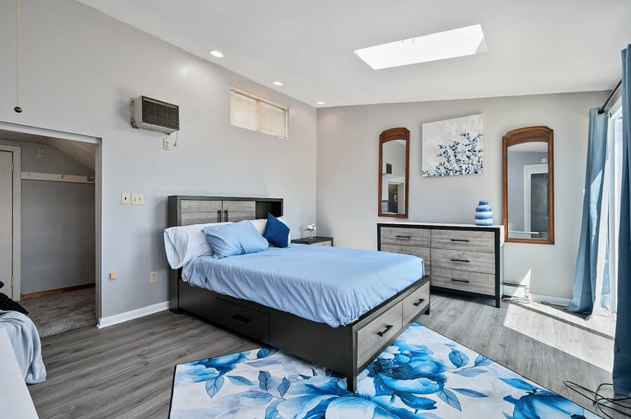 Master bedroom with storage beneath and additional dresser
