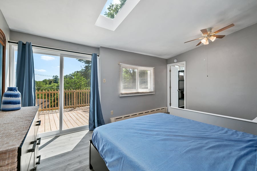 Master bedroom with sliding glass door access to upper deck