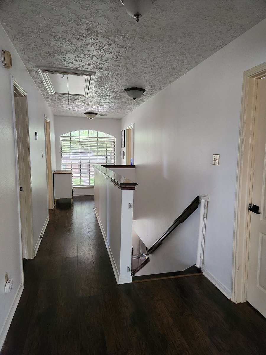 Upstairs hallway between rooms and bathroom