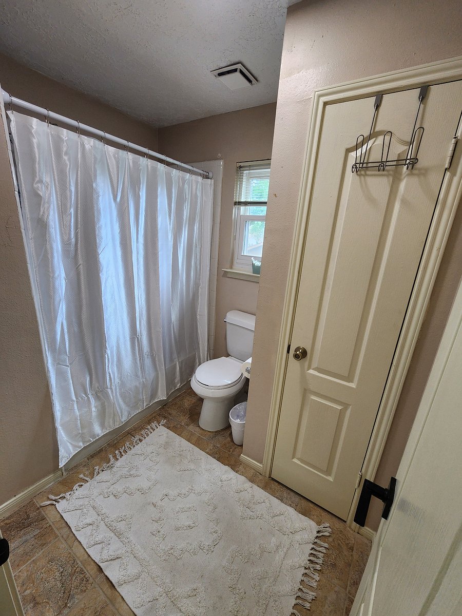 Toilet and bath in secondary guest room are separated with a door from the sink area