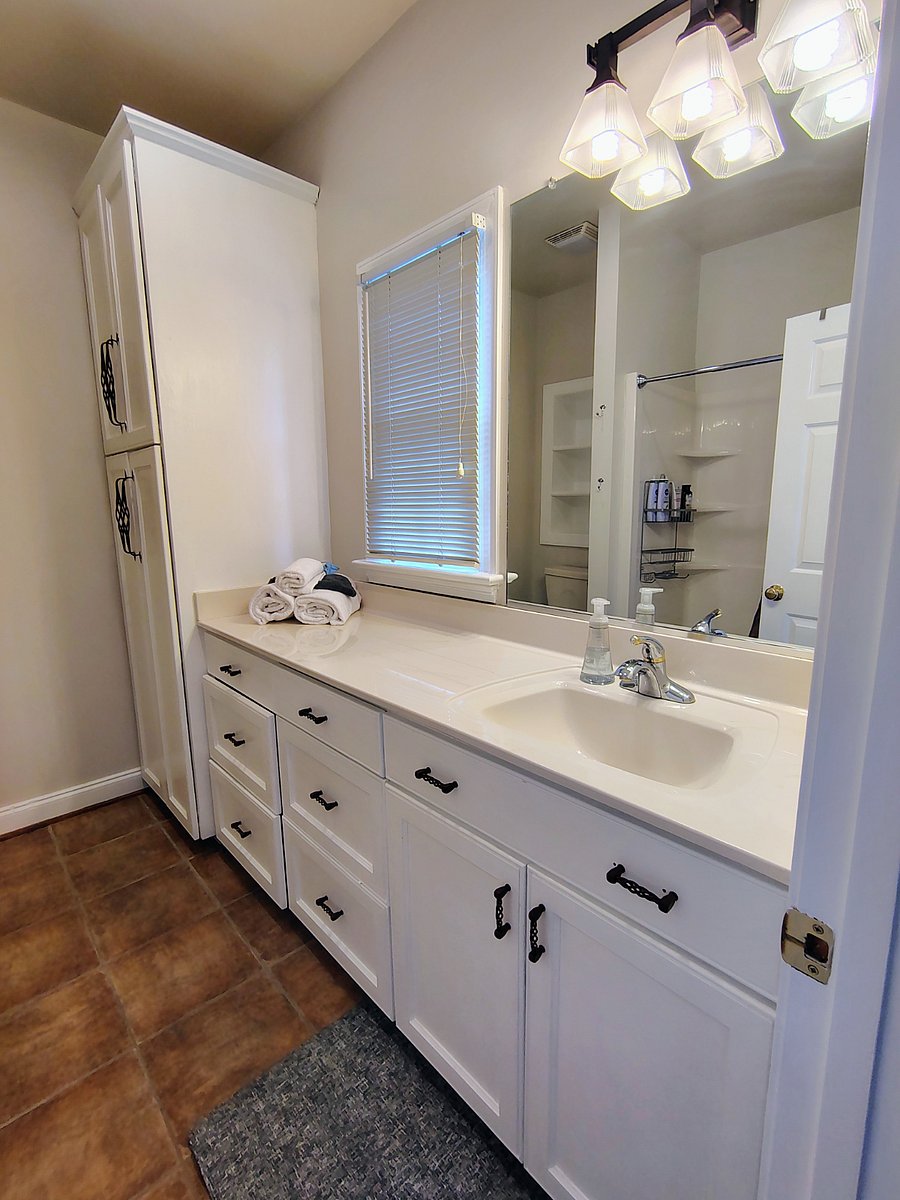 PARKVIEW-ensuite bathroom has an incredible amount of counterspace, large drawers, and floor to ceiling cabinet, plus a window that can be opened for fresh air!