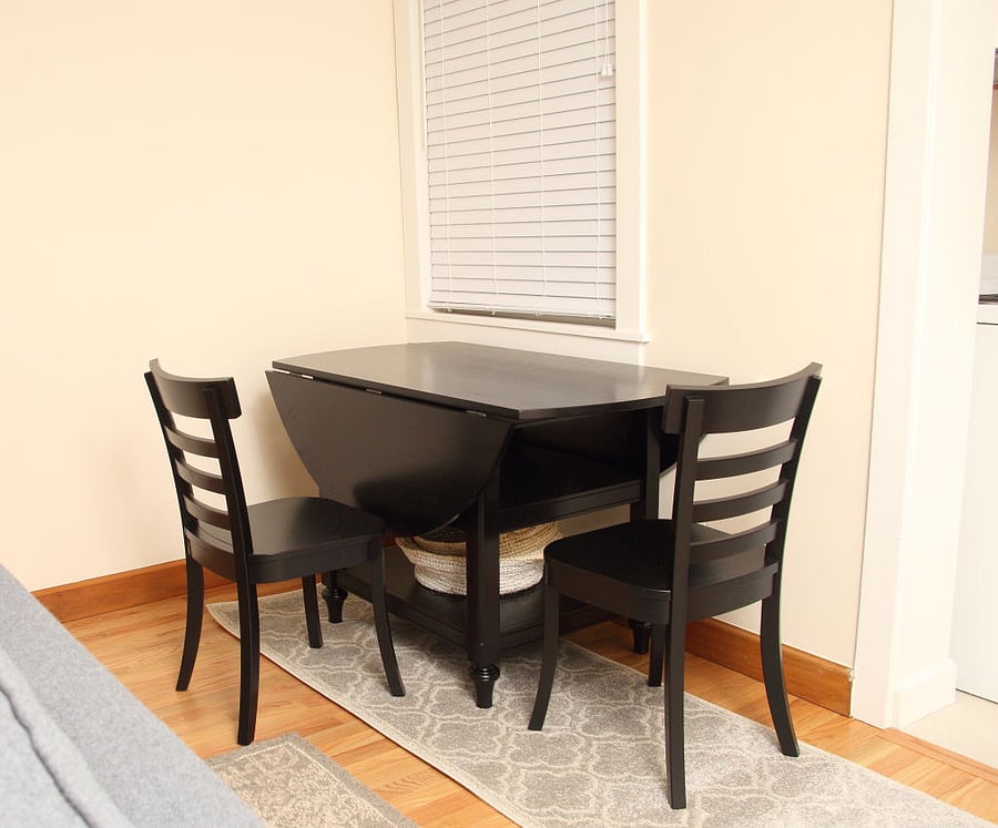 Table has two folding sides (one shown) to accommodate 4 dining chairs.