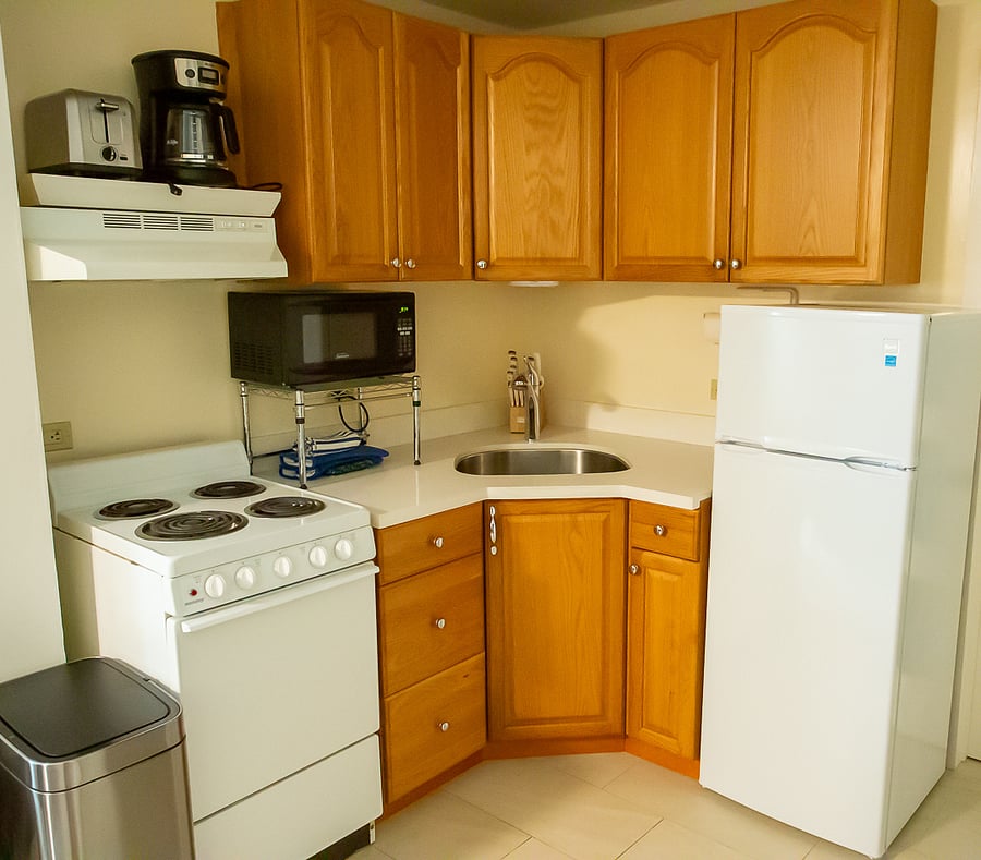 Kitchen has range, microwave, refrigerator, toaster, coffee maker
