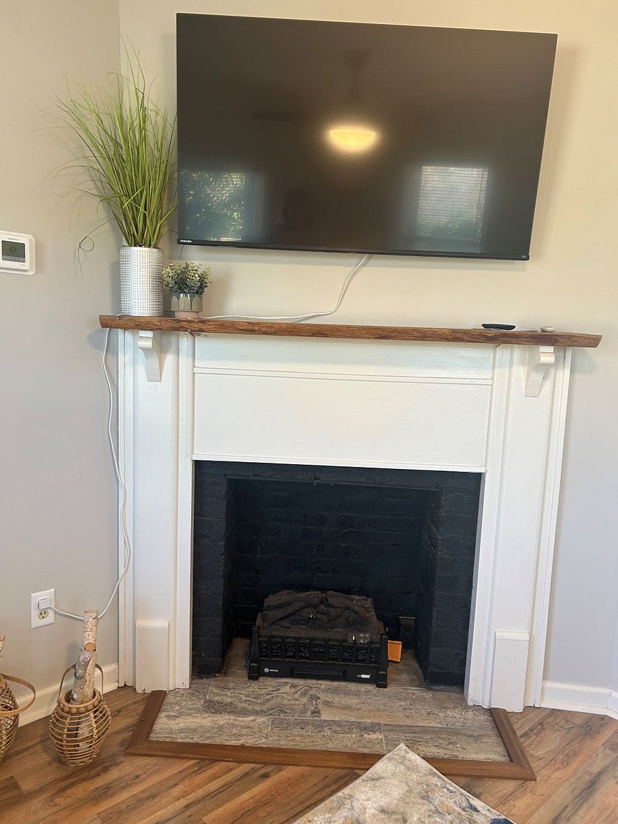 Smart TV is above the fireplace mantle.