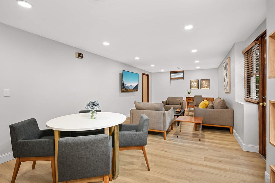 Lower Level family room with wall mounted smart TV and dedicated work-from-home area