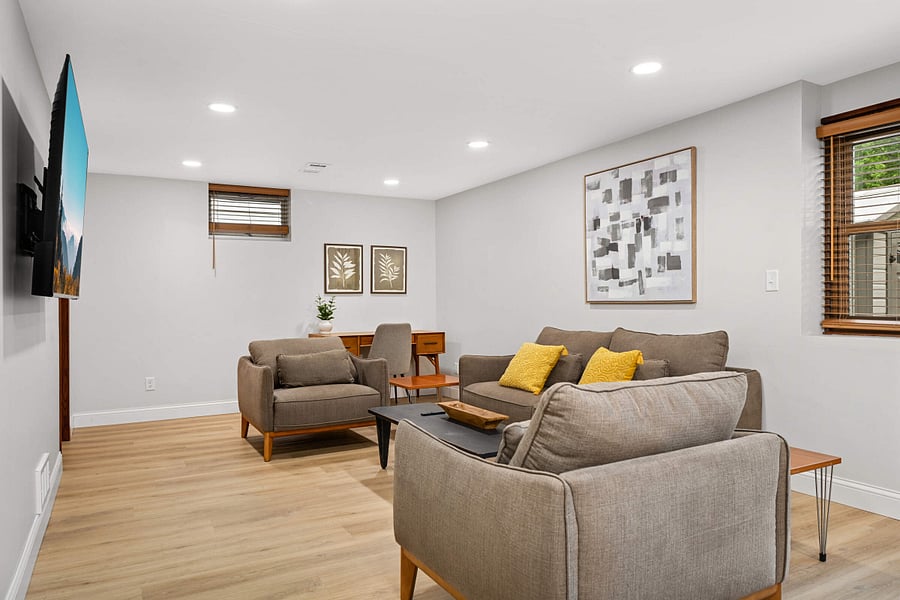 Lower Level family room with wall mounted smart TV and dedicated work-from-home area