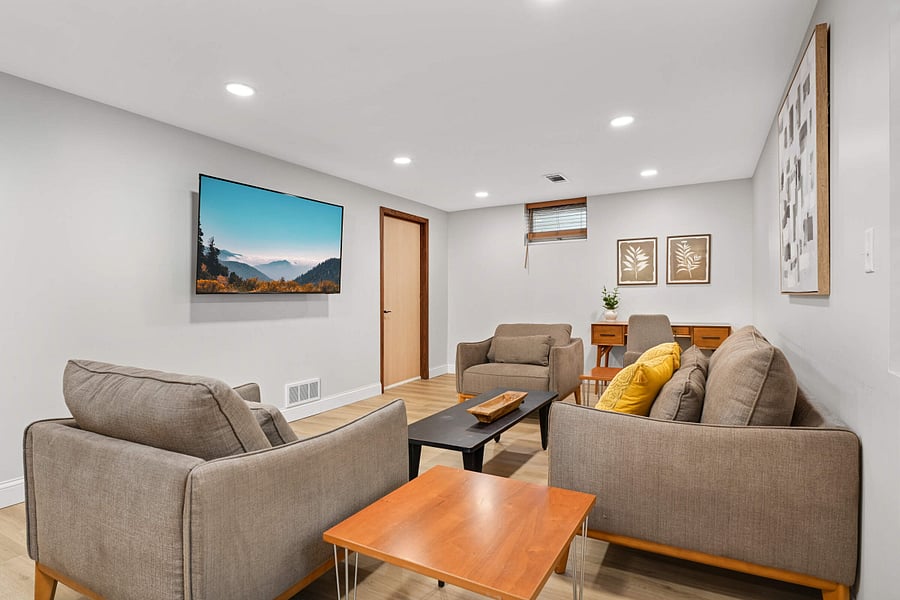 Lower Level family room with wall mounted smart TV and dedicated work-from-home area