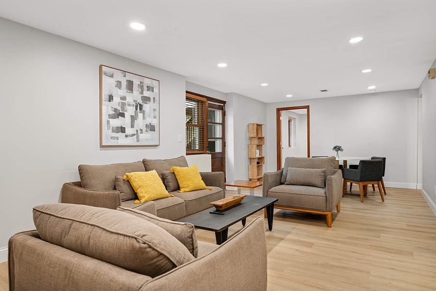 Lower Level family room with wall mounted smart TV and dedicated work-from-home area