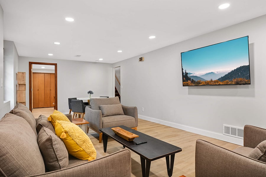 Lower Level family room with wall mounted smart TV and dedicated work-from-home area