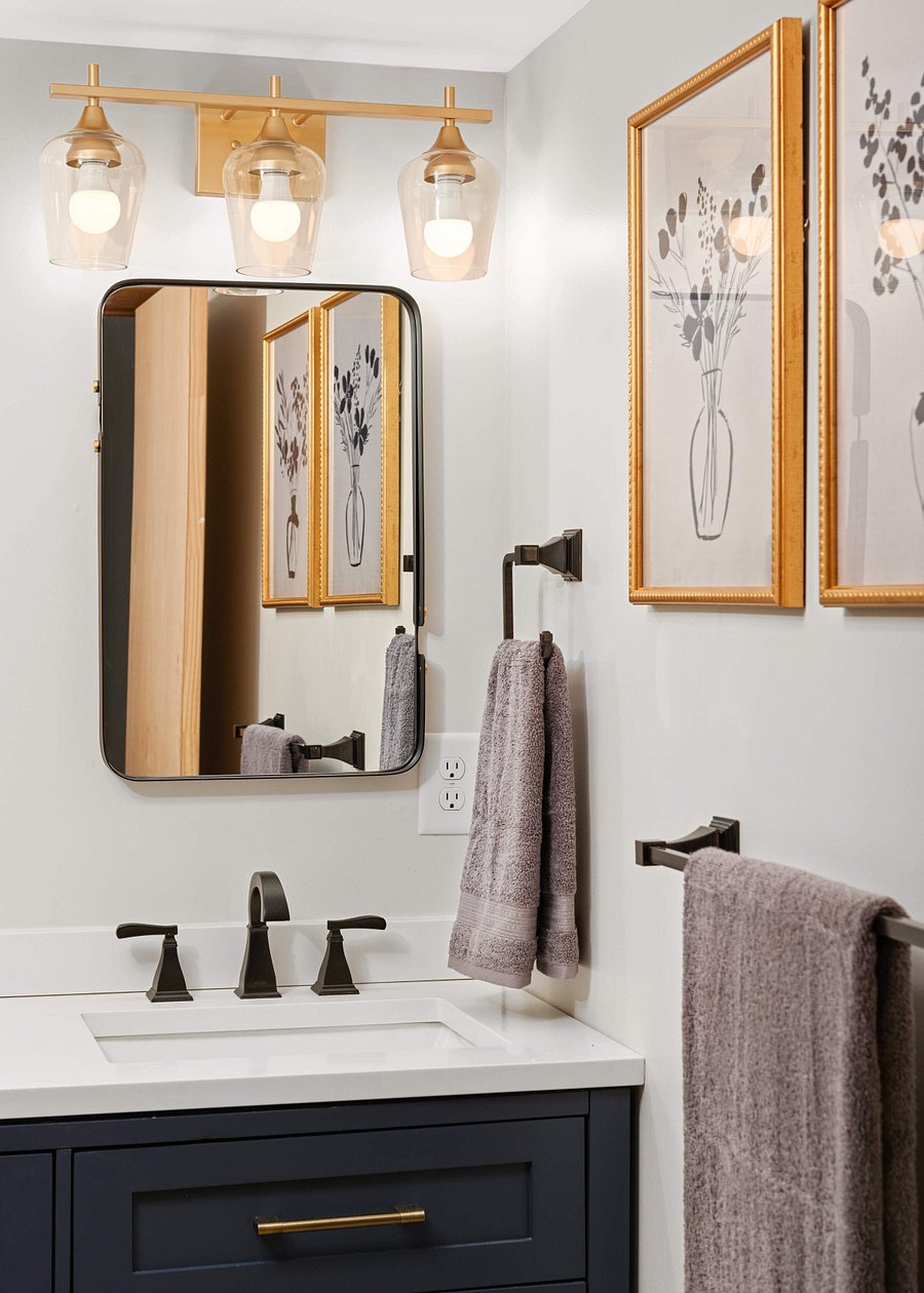 Lower Level fully renovated bathroom with double sink, separate walk in shower and toilet area