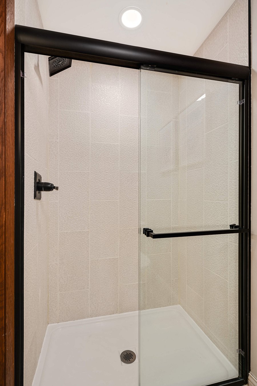 Lower Level fully renovated bathroom with double sink, separate walk in shower and toilet area