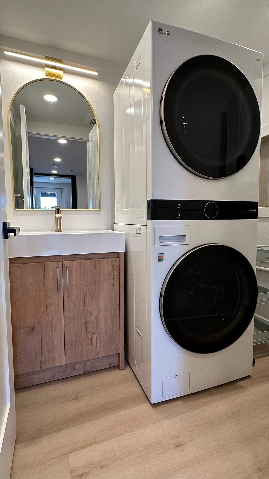 Laundry room with extra sink, stocked with detergent for easy, hassle-free washing.