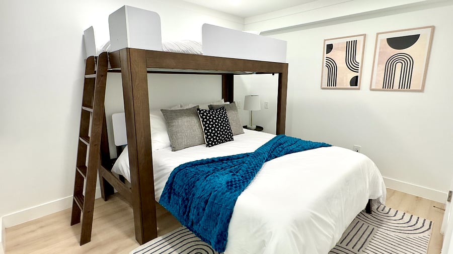 Cozy and inviting bedroom featuring a plush queen bed and a twin bunkperfect for any use!