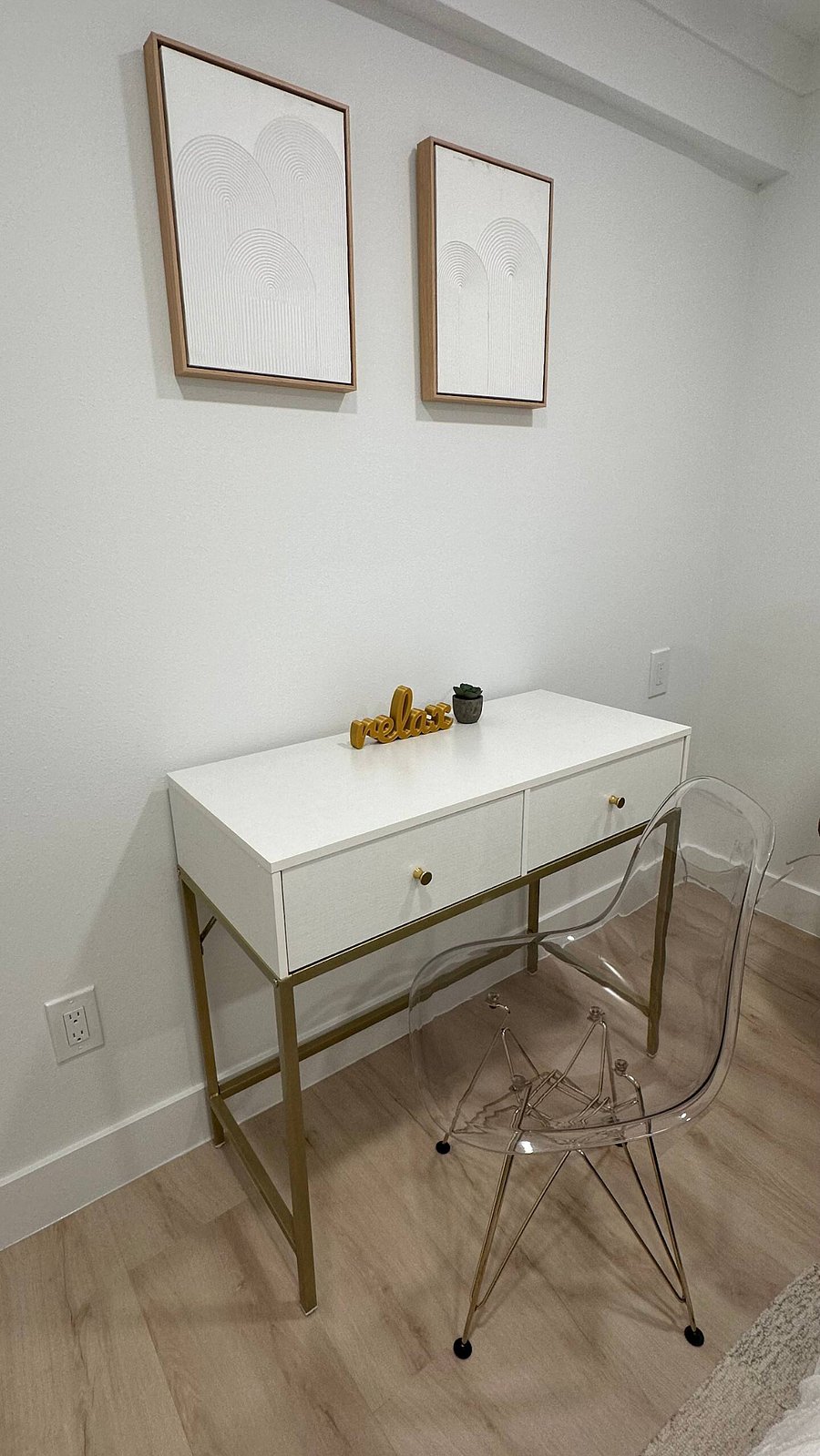 This sleek work desk in one of the bedroom spaces doubles as a vanity, featuring a spacious tabletop and built-in drawers.